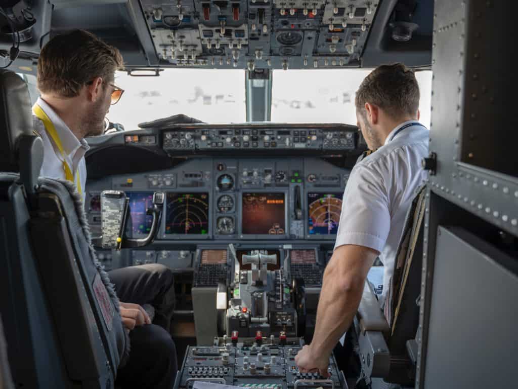 two pilots sitting inside plane 2064123